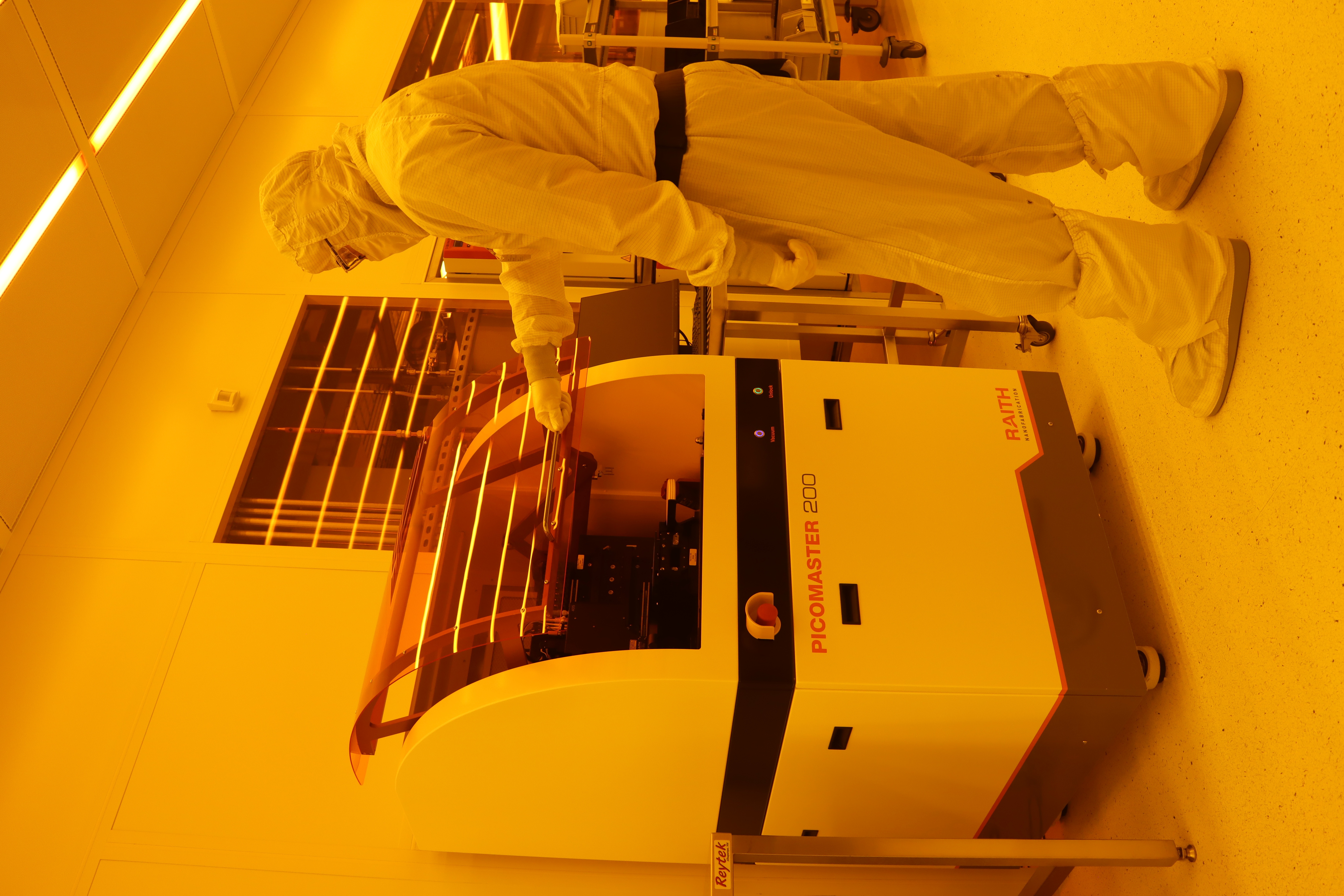 A person at the Picomaster tool inside MIT.nano's cleanroom.