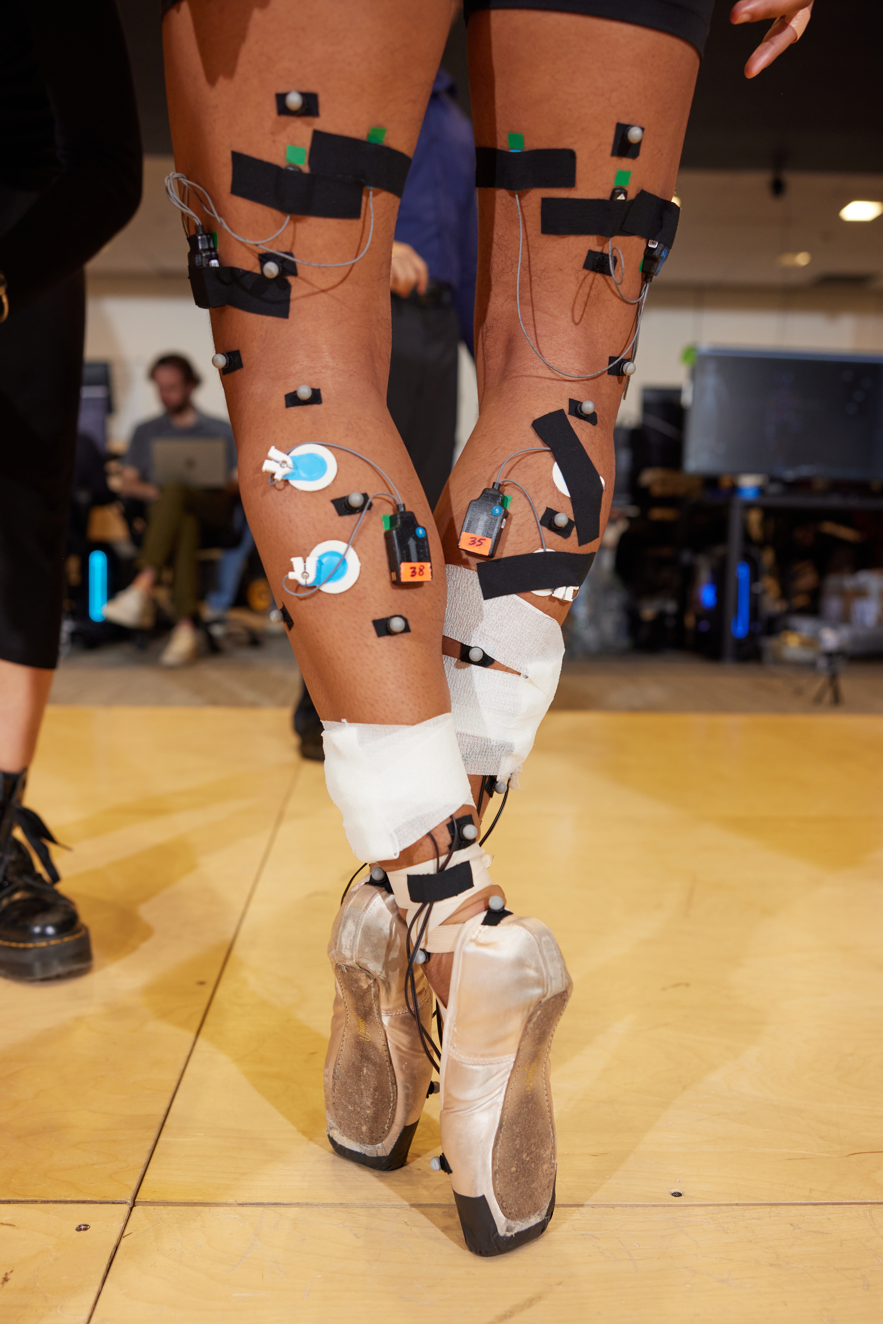 A dancer wears ballet shoes and motion sensors