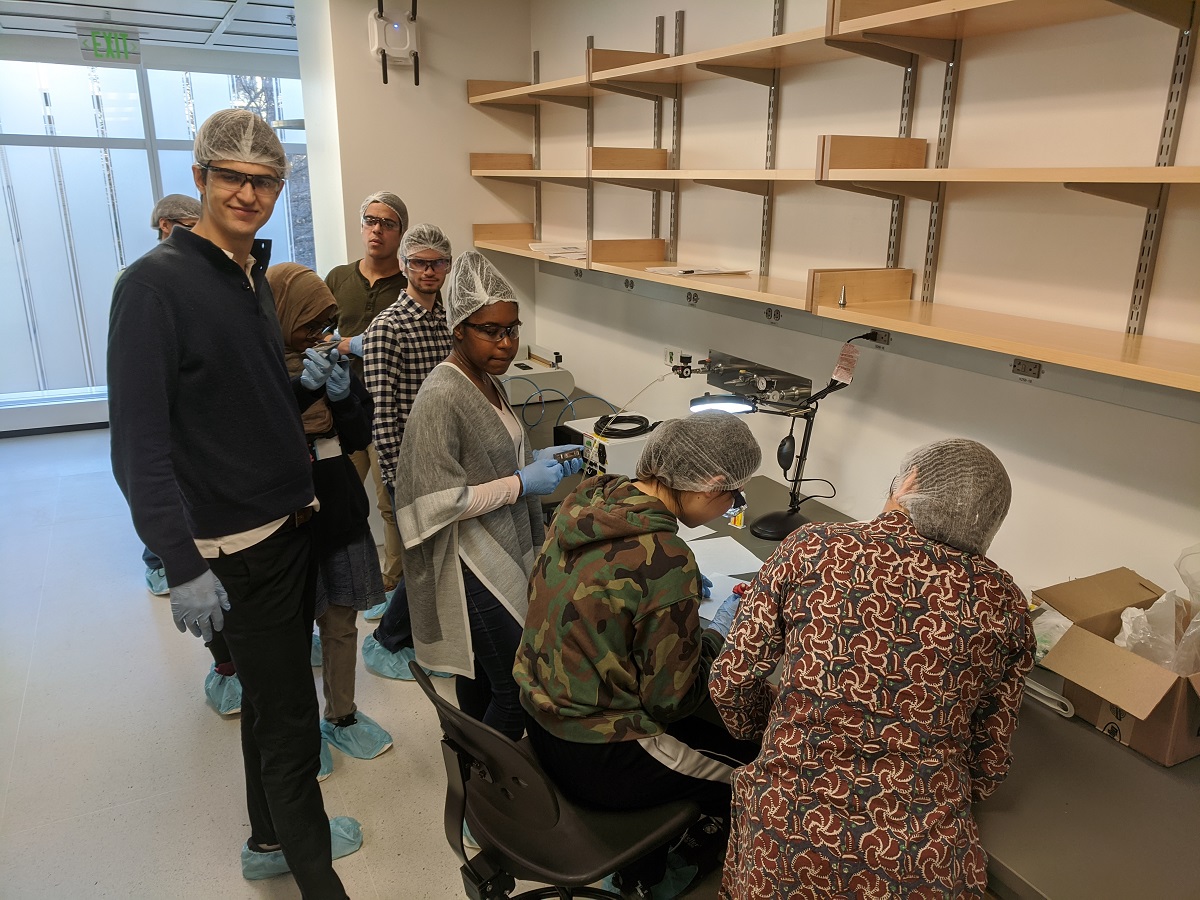 students apply epoxy to solar cells